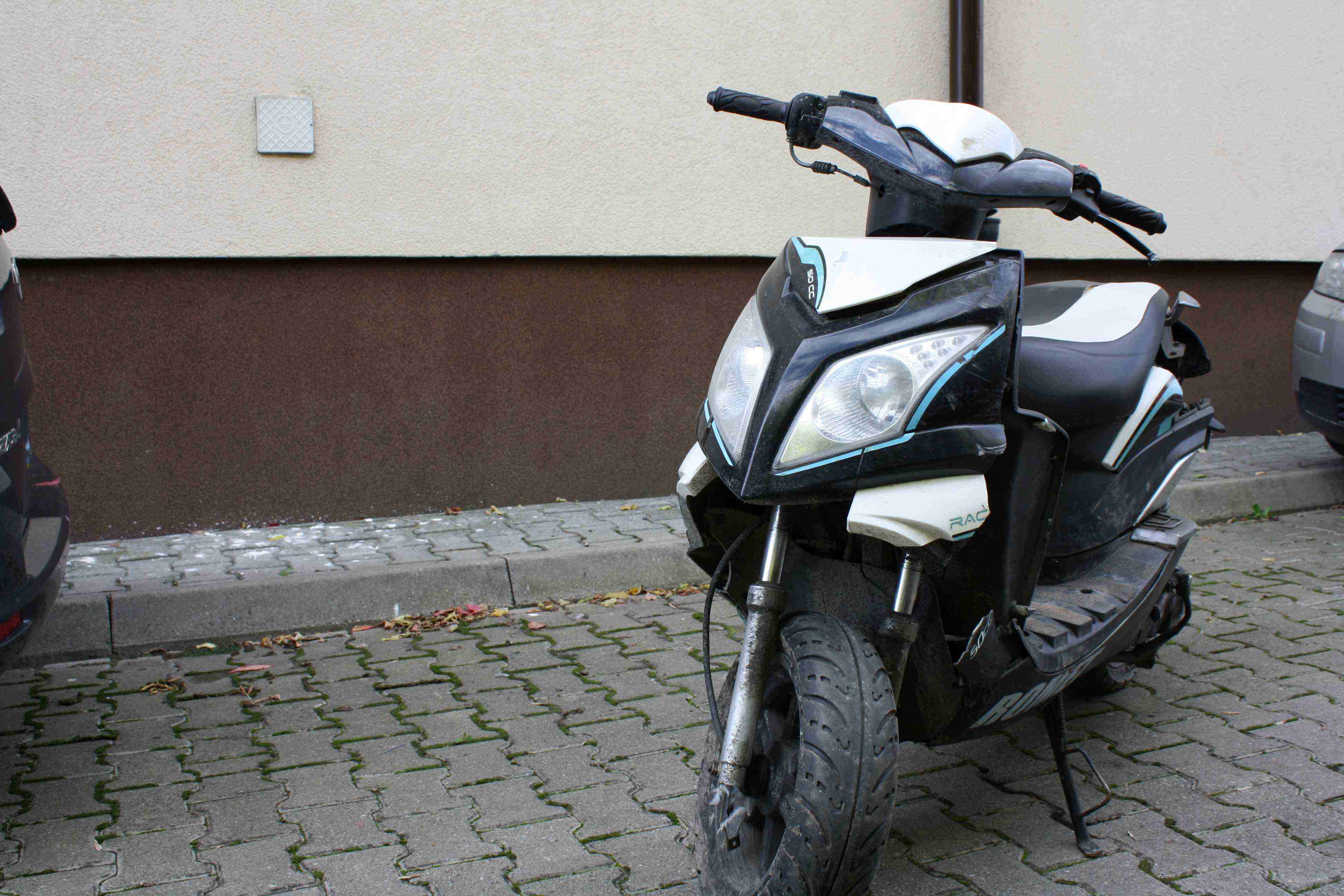widok przodu motoroweru z widocznymi uszkodzeniami plastikowych elementów