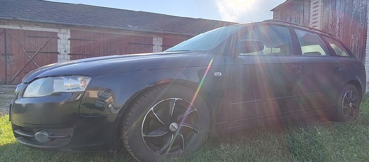 Samochód Audi A4 w kolorze czarnym widoczny od boku z prawej strony.