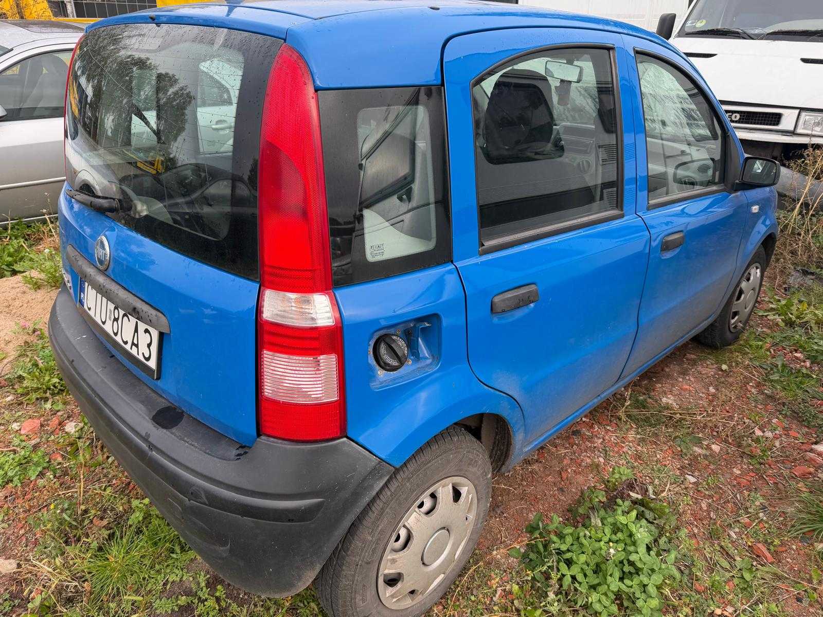 Prawy bok pojazdu w kolorze niebieskim, widoczny brak pokrywy wlewu paliwa