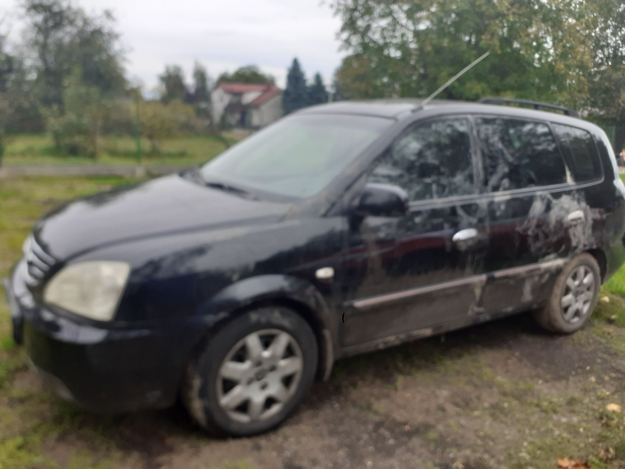 Samochód widziany z lewej strony z widocznym obtarciem i zarysowaniem na całej długości .