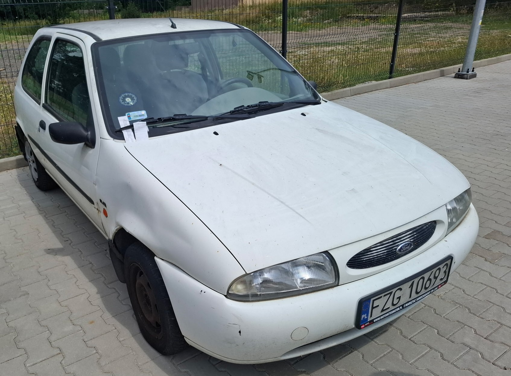 Biały Ford Fiesta, widok z przodu i lewego boku.