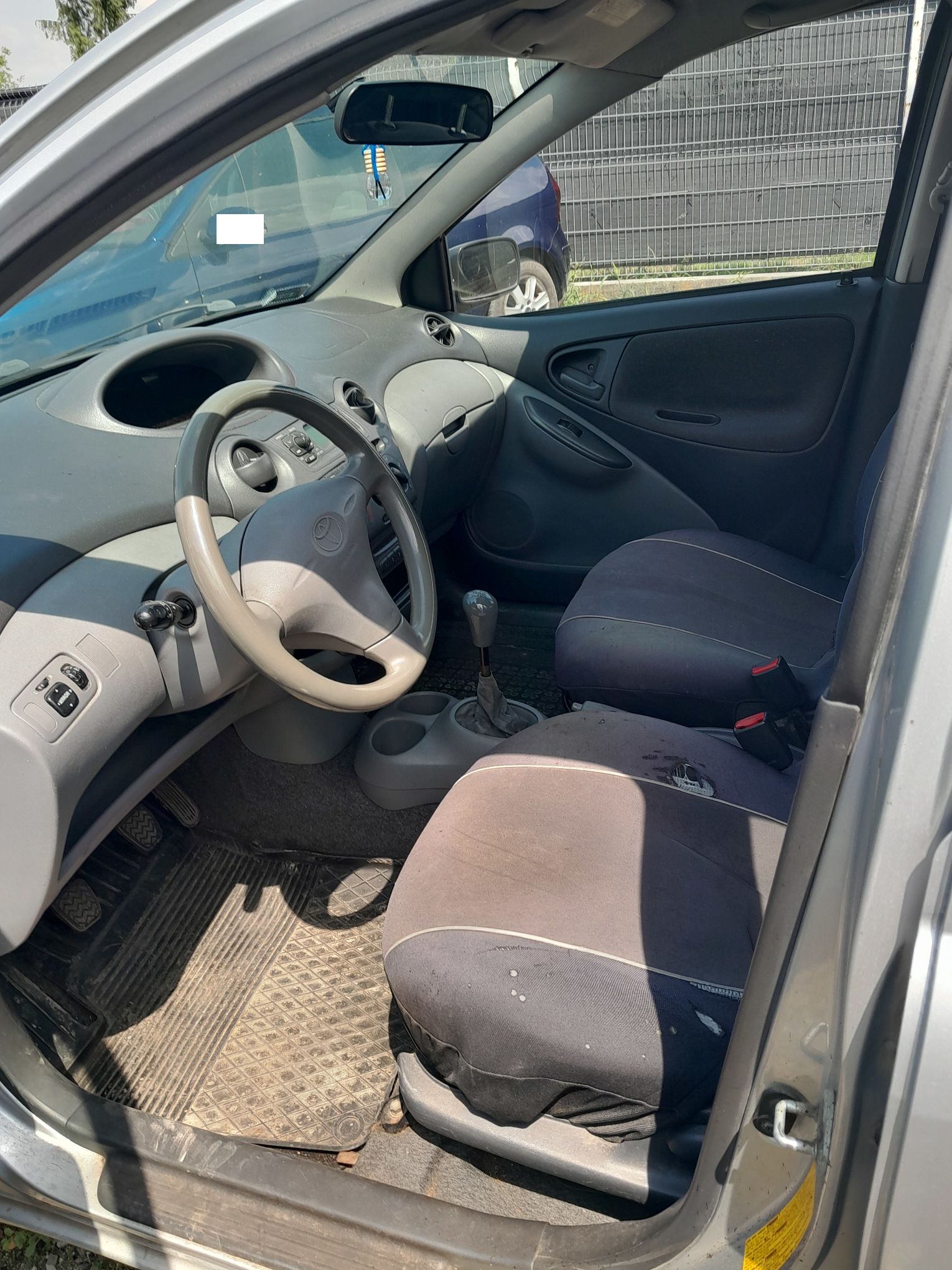 Wnętrze Toyoty Yaris z szarymi fotelami, kierownicą i deską rozdzielczą