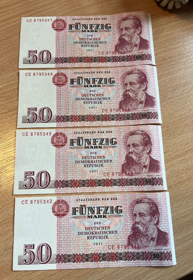Cztery historyczne banknoty o nominale 50 marek NRD z 1971 roku ułożone jeden pod drugim.
