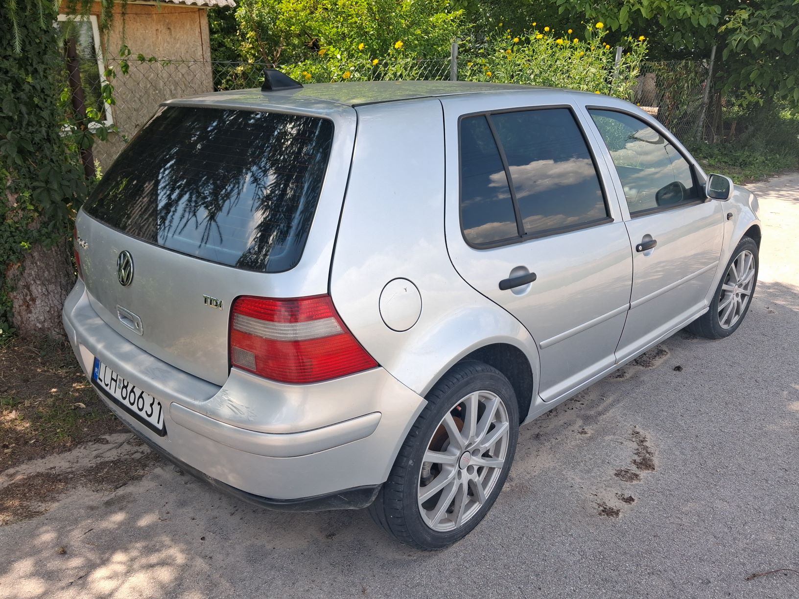 Prawy bok samochodu osobowego w kolorze srebrnym.