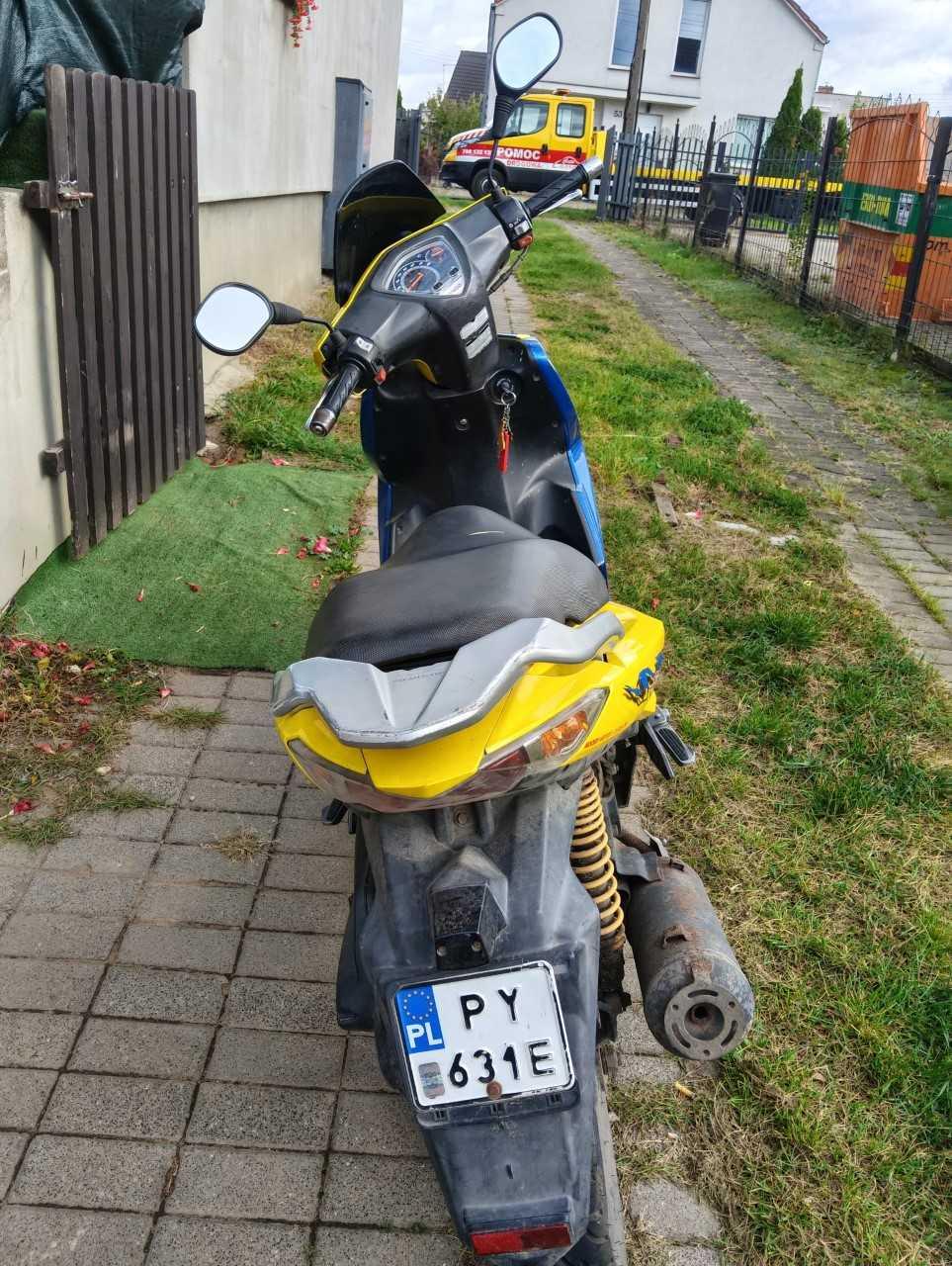 Tył pojazdu, siedzisko jest pokryte czarnym materiałem i ma dwupoziomowy, sportowy profil.
