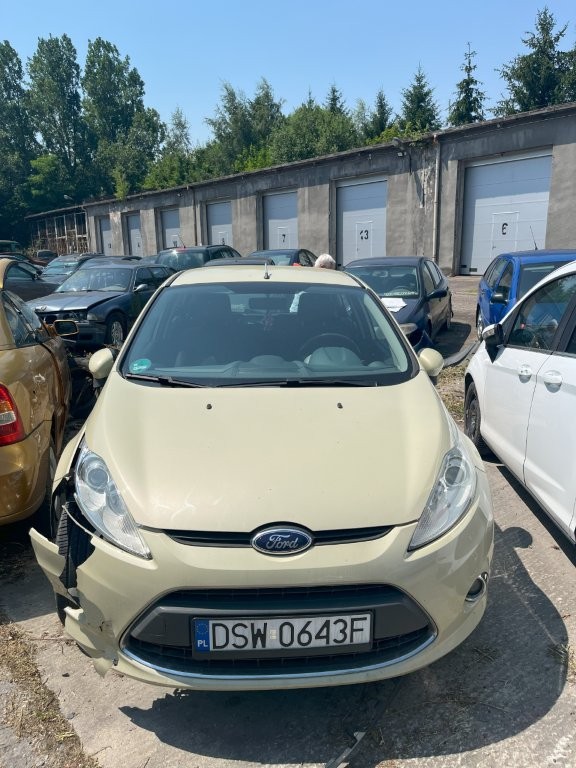 Przód pojazdu z widocznymi reflektorami i rozbitym zderzakiem i prawym nadkolem