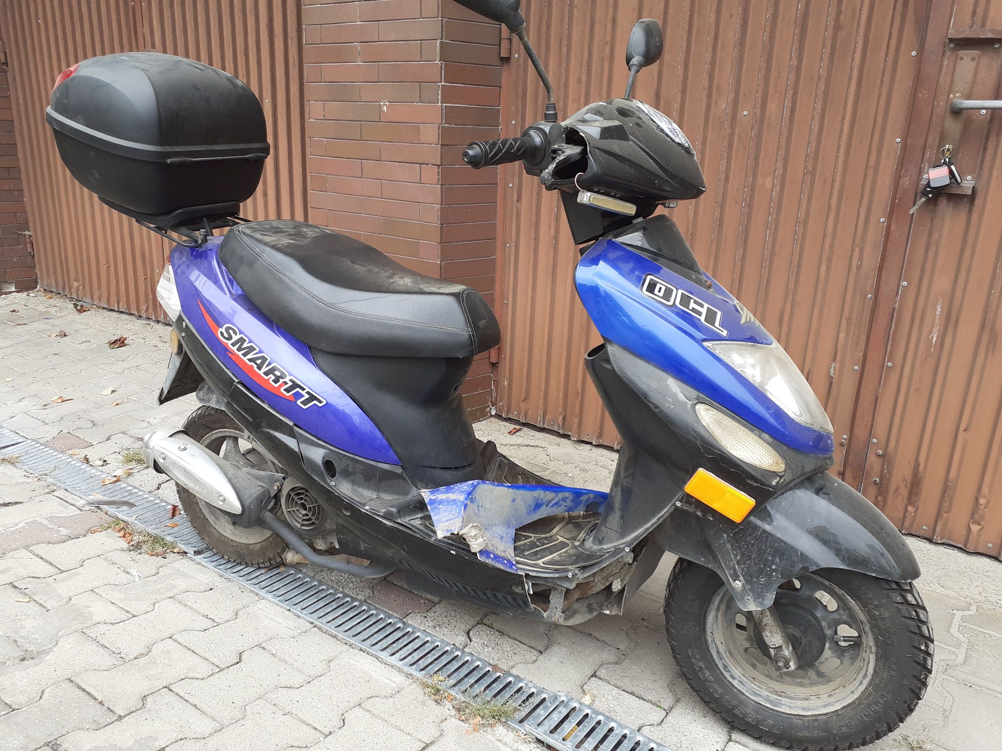 motorower widziany z prawej strony z widocznym uszkodzeniem