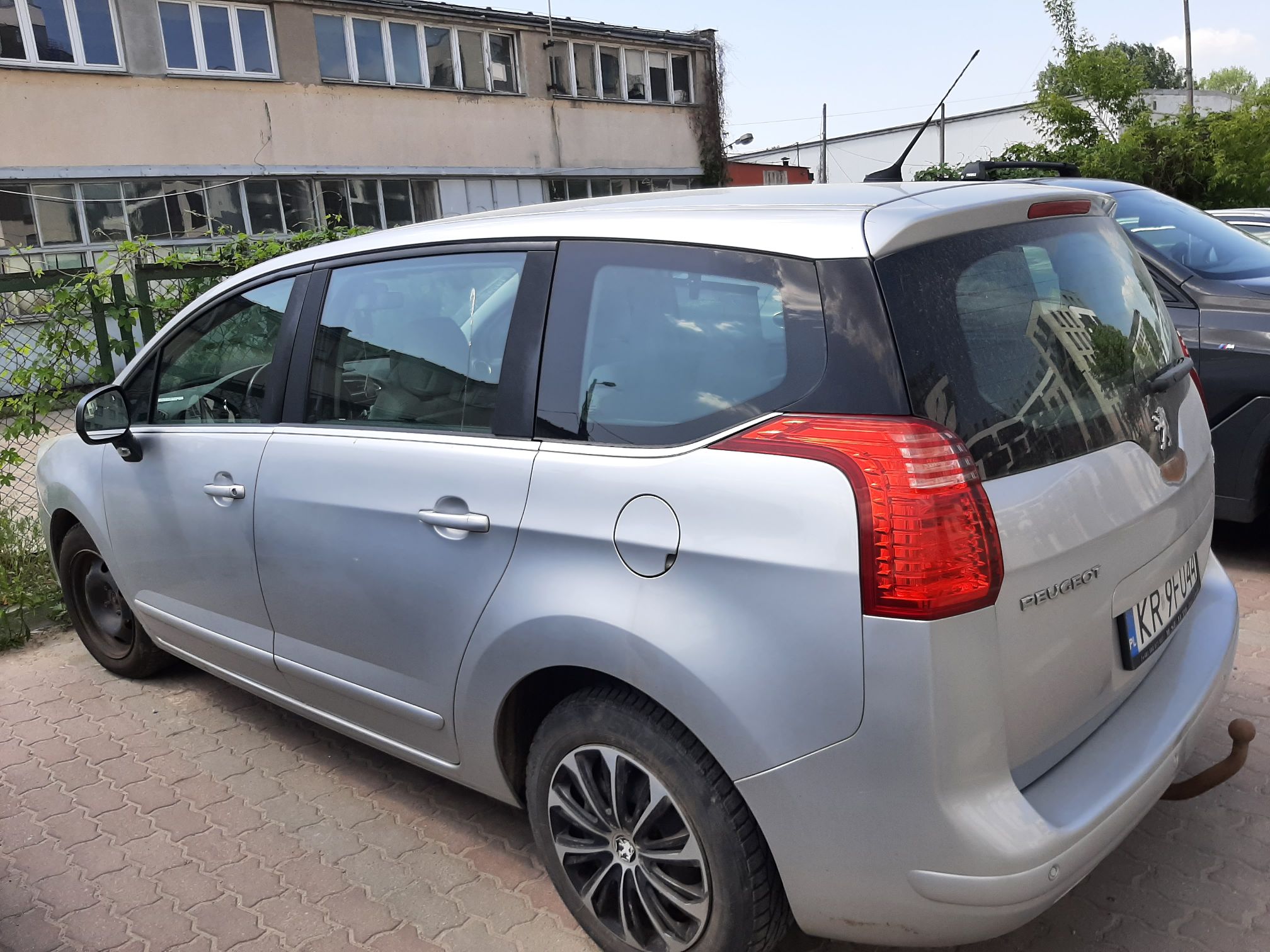 Lewa strona pojazdu Peugeot 5008 kolor srebrny, widok od tyłu.