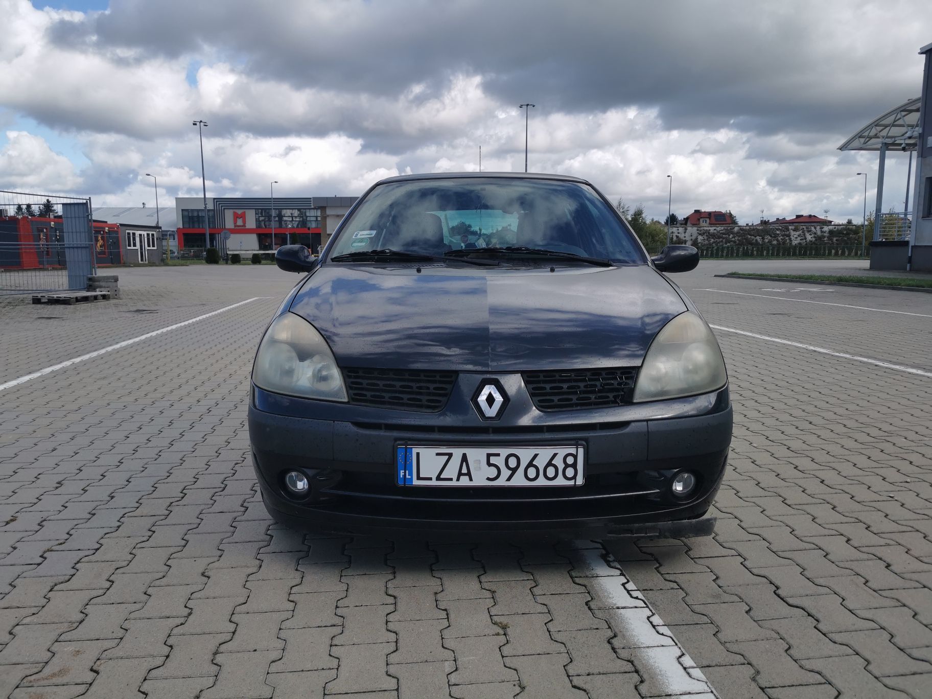 Przód pojazdu. Pokrywa silnika z zagnieceniami. Przedni zderzak, przednie reflektory. Tablica rejestracyjna.